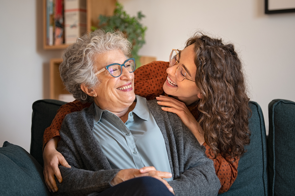 Woman holding elderly woman